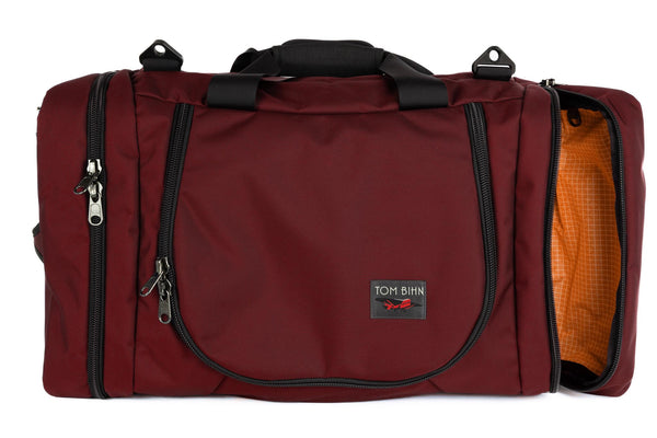 A Mars Red (brick red) Ballistic Aeronaut 45 with the end pocket open showing the Zest (orange) Halcyon.
